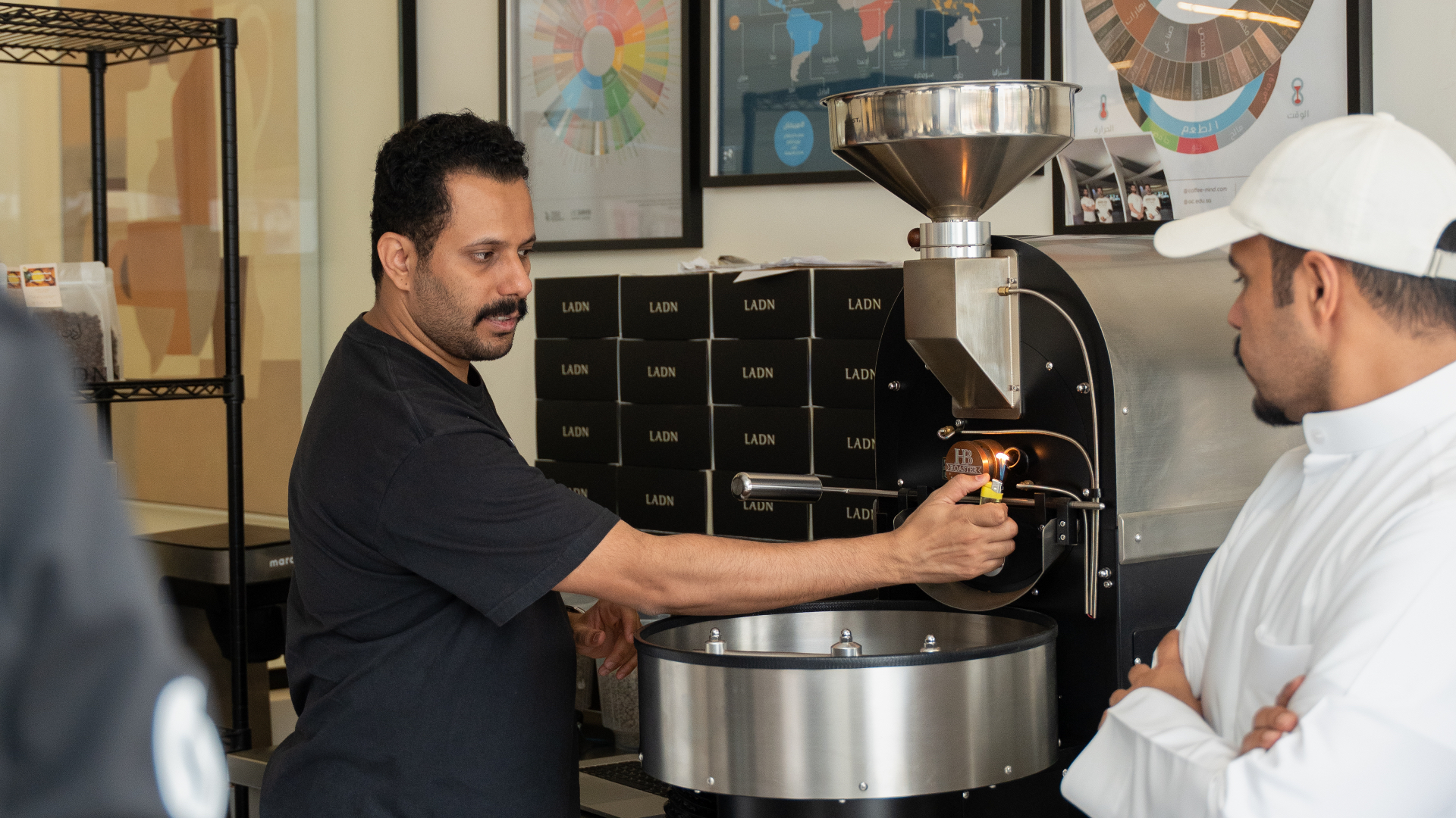 Roasting instructor guiding a trainee at the coffee roaster